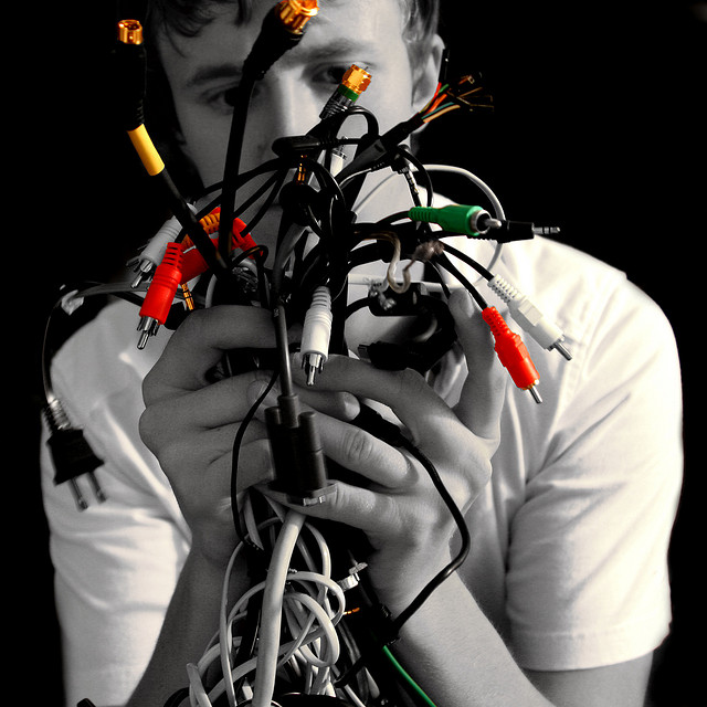 man holding a bunch of electronic cables