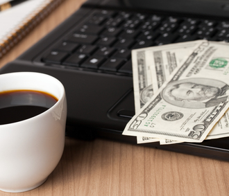 laptop with money and coffee